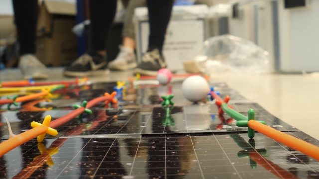 STEM learning game with feet in background.